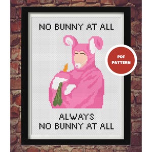 May include: Cross-stitch art framed in black, featuring a figure in a pink bunny costume holding a carrot and a green bottle. The text reads "NO BUNNY AT ALL" above and "ALWAYS NO BUNNY AT ALL" below. A red circle with "PDF PATTERN" is in the upper right.