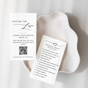 May include: A white card with black text that says "I Spy Wedding Photo Challenge" with a list of items to find in wedding photos. The card is on a white surface.
