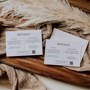 May include: Two white cards with the word "DETAILS" printed in black at the top. The cards are divided into two sections, "Reception" and "Accommodations". The text on the cards provides information about the reception and accommodations for a wedding. The cards also include a QR code.