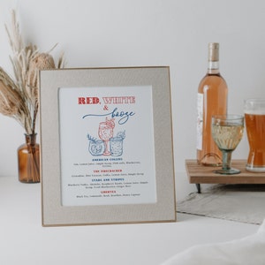 May include: A framed print with a red, white, and blue color scheme. The print features a list of cocktails with names like "American Collins", "The Firecracker", "Stars and Stripes", and "Libertea".