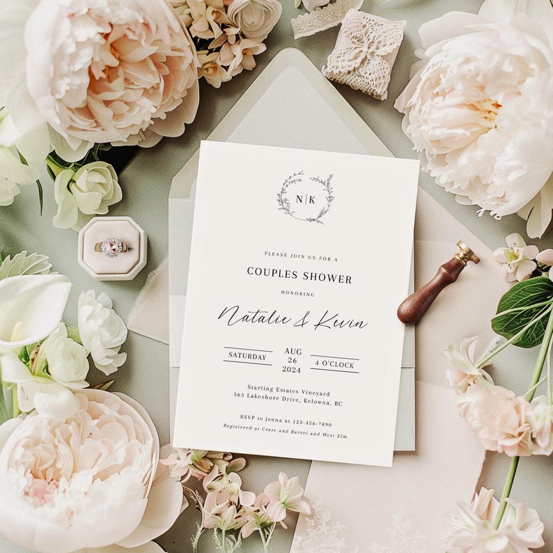 May include: A white wedding invitation with a floral wreath and the initials "N.K." at the top. The invitation is for a couples shower honoring Natalie & Kevin. The date is Saturday, August 26, 2024, at 4 o'clock. The location is Starling Estates Vineyard, 563 Lakeshore Drive, Kelowna, BC. RSVP to Jenna at 123-456-7000. Registered at Crate and Barrel and West Elm.