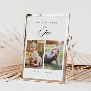 May include: A silver picture frame with two photos of babies. The text "When we were One" is at the top of the frame. The text "Gianna + Lincoln 08.26.20XX" is at the bottom of the frame.