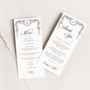 May include: Two white cards with black text and floral designs. The first card is a menu with the text "Menu" in a decorative font. The second card is a thank you card with the text "Thank You" in a decorative font. Both cards have the text "Penelope & Julian" at the bottom.