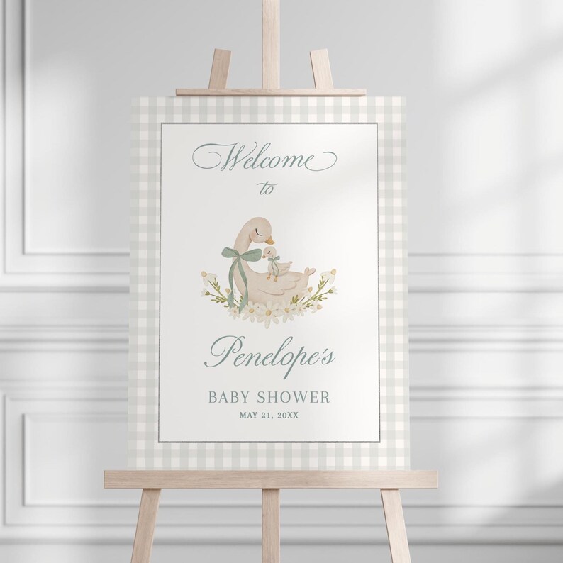 May include: Welcome to Penelope's Baby Shower sign with a white and gray gingham background. A watercolor illustration of a mother duck and her duckling is featured in the center of the sign. The text reads "Welcome to Penelope's Baby Shower May 21, 20XX".