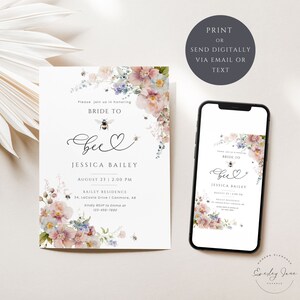 May include: A floral bridal shower invitation with a bee and the text "Bride to Bee" in a handwritten font. The invitation is printed on white cardstock and features a watercolor floral design with pink, blue, and green flowers. The text "Jessica Bailey" is printed below the bee and the date and time of the shower are printed below that. The invitation also includes the address of the shower and a request to RSVP to Emma at a phone number.