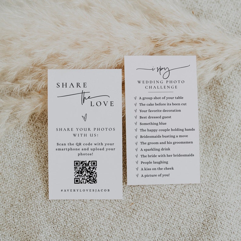 May include: Two white cards with black text. The left card says "Share the Love" and has a QR code. The right card says "I Spy Wedding Photo Challenge" and has a list of items to find in wedding photos.