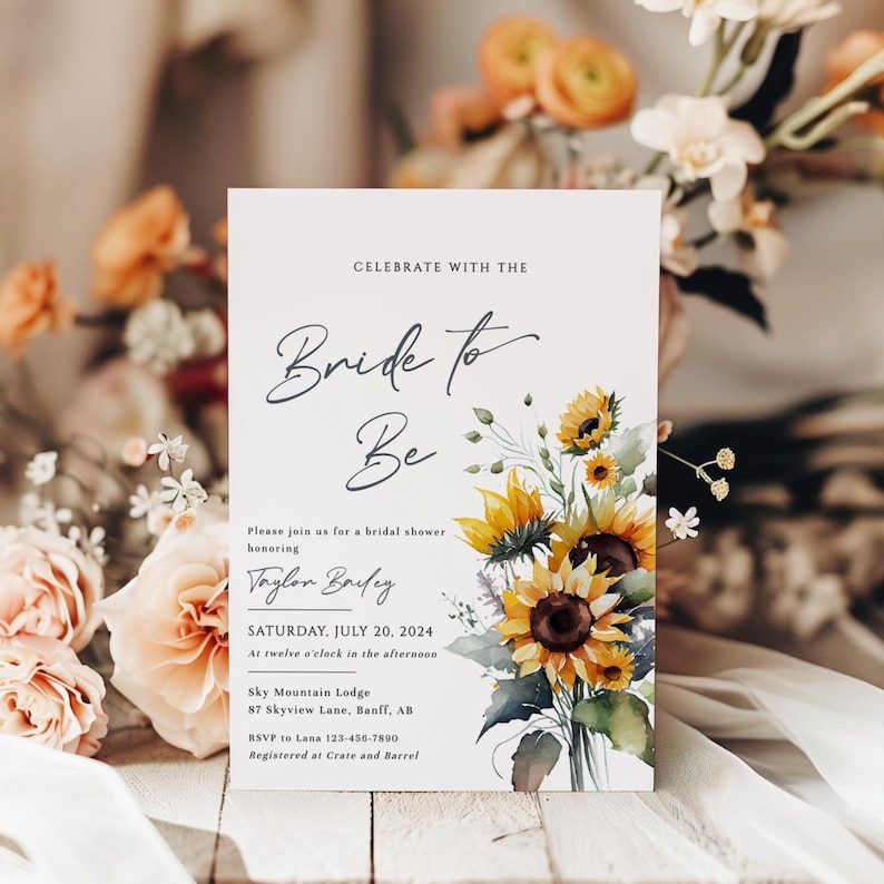 May include: A white invitation card with the text "Bride to Be" in elegant script, adorned with watercolor sunflowers. The card includes details for a bridal shower, including the date, time, and location.