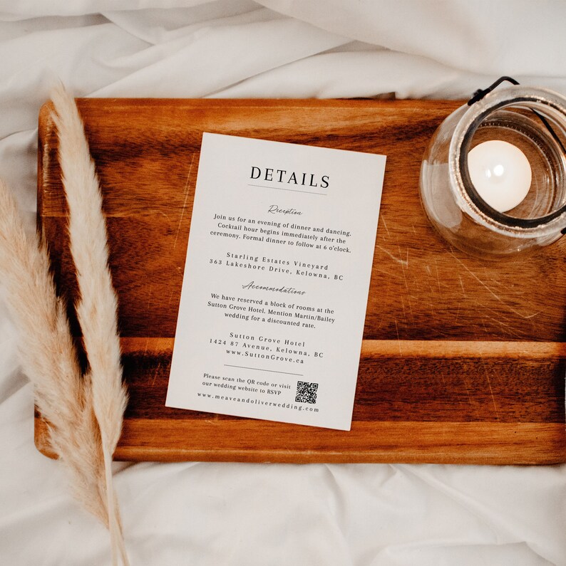 May include: A white card with black text detailing wedding reception information. The card is on a wooden surface with a candle in a glass jar. The text includes the location, time, and accommodations for the wedding reception.