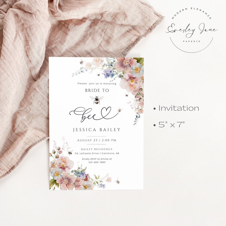 May include: A floral bridal shower invitation with a bee and heart design. The invitation is for Jessica Bailey and is set for August 23rd at 2:00 PM. The invitation is 5 inches by 7 inches.