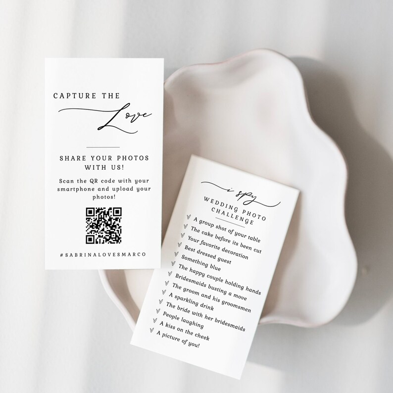 May include: A white card with black text that says "I Spy Wedding Photo Challenge" with a list of items to find in wedding photos. The card is on a white surface.