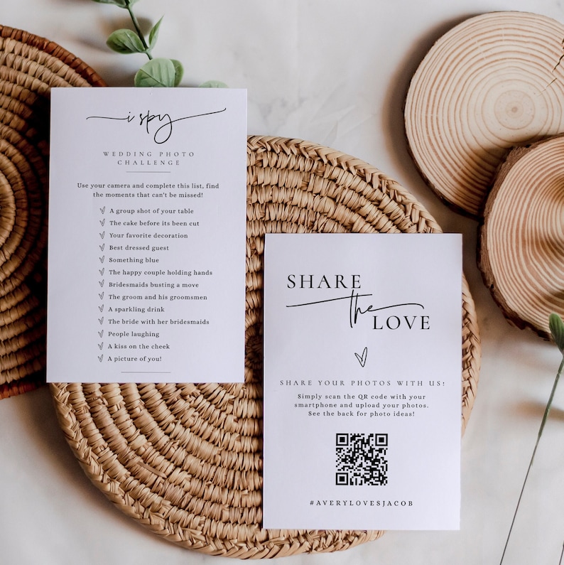 May include: Two white cards with black text. The first card has a checklist titled "I Spy Wedding Photo Challenge" with a list of wedding photo ideas. The second card says "Share the Love" and has a QR code with the text "Share your photos with us: Simply scan the QR code with your smartphone and upload your photos. See the back for photo ideas! #AVERYLOVESJACOB".
