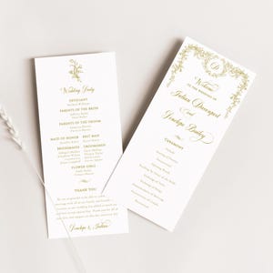 May include: A wedding ceremony program with gold lettering on a white background. The program includes the names of the officiant, parents of the bride and groom, maid of honor, best man, bridesmaids, groomsmen, and flower girls. The program also includes the ceremony order, which includes the prelude, seating of parents, processional, opening words, reading by a guest of the bride, exchange of vows, exchange of rings, announcement of marriage, presentation of couple, and recessional.