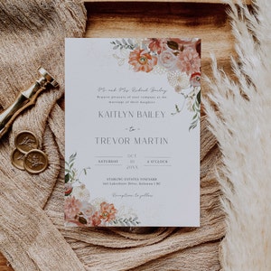 May include: A wedding invitation featuring a floral design in shades of pink, peach, and green. The invitation is for Kaitlyn Bailey and Trevor Martin, and it states the wedding will take place on 10 October 20XX at 4:00 PM at Starling Estates Vineyard in Kelowna, BC.