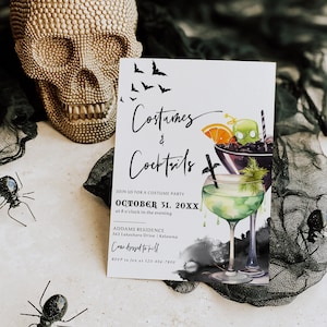 May include: A white invitation card with black text and illustrations. The text reads "Costumes & Cocktails" and "Join us for a costume party October 31, 20XX at 8 o'clock in the evening Addams Residence 363 Lakeshore Drive | Kelowna Come dressed to kill RSVP to Jen at 123-456-7890". The illustrations are of two cocktails, one green and one purple, with bats flying in the background.