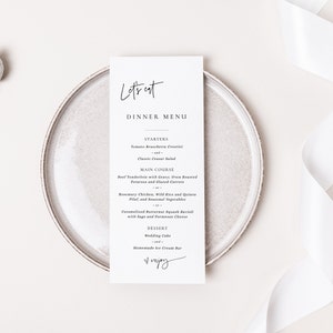 K&ouml;nnte beinhalten: Eine wei&szlig;e Speisekarte mit schwarzem Text. Die Speisekarte tr&auml;gt den Titel "Let's Eat Dinner Menu". Die Speisekarte listet Vorspeisen, Hauptgerichte und Desserts auf. Die Speisekarte endet mit dem Wort "Enjoy", das in Kursivschrift geschrieben ist.