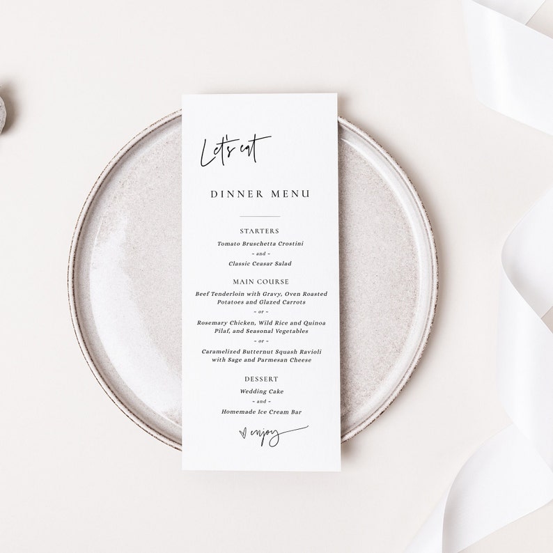 K&ouml;nnte beinhalten: Eine wei&szlig;e Speisekarte mit schwarzem Text. Die Speisekarte tr&auml;gt den Titel "Let's Eat Dinner Menu". Die Speisekarte listet Vorspeisen, Hauptgerichte und Desserts auf. Die Speisekarte endet mit dem Wort "Enjoy", das in Kursivschrift geschrieben ist.