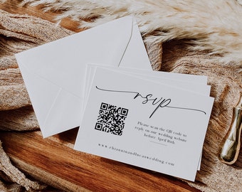 May include: A white RSVP card with a black QR code and the text "Please scan the QR code to reply on our wedding website before April 16th. www.rhianninandlucaswedding.com"