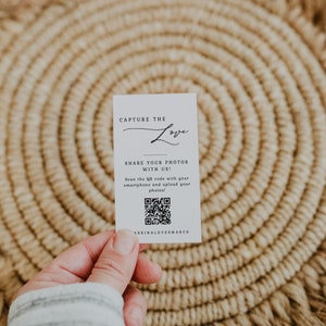 May include: White card with black text that reads "Capture the Love" and "Share your photos with us!" with a QR code and the text "ABRINALOVESMARCO" at the bottom.