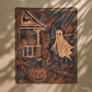 May include: A Halloween-themed throw blanket featuring a dark blue backdrop with pumpkins, a ghost, and a house design. The blanket has a fringed edge and is made of a soft material. The color scheme includes orange, brown, and black hues.