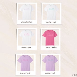 May include: Six different color variations of a t-shirt with a graphic design of a line drawing of a group of people. The colors are white, pink, teal, berry, orchid, and violet.