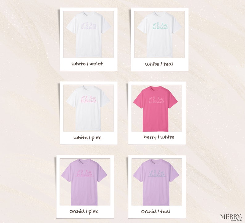 May include: Six different color variations of a t-shirt with a graphic design of a line drawing of a group of people. The colors are white, pink, teal, berry, orchid, and violet.