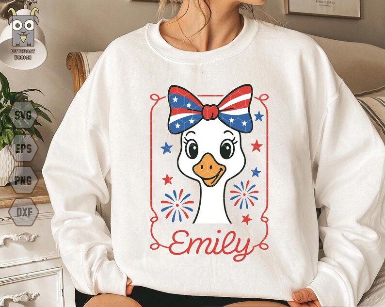 May include: White sweatshirt with a red, white, and blue goose wearing a bow. The goose has a white body and a red beak. The bow is red, white, and blue with stars. The text "Emily" is below the goose.