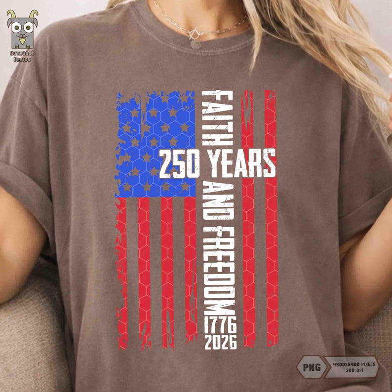May include: A brown t-shirt featuring a distressed American flag design. The flag incorporates blue and white stars, red and white stripes, and the text "FAITH AND FREEDOM 250 YEARS 1776 2026" in white. The shirt has short sleeves.