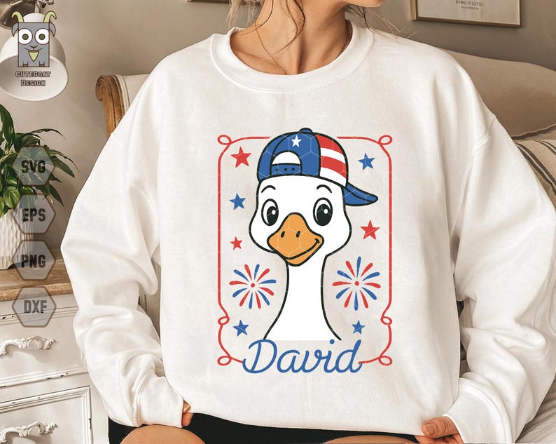 May include: White sweatshirt with a cartoon goose wearing a red, white, and blue baseball cap. The goose is wearing a red, white, and blue baseball cap with stars and stripes. The goose is surrounded by fireworks and the word "David" is written below the goose.