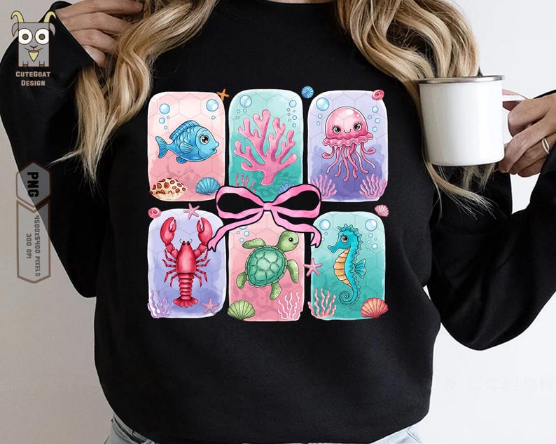 May include: A black sweatshirt with a colorful graphic of sea creatures in a gift box design. The graphic features a pink bow, a blue fish, a pink jellyfish, a red lobster, a green sea turtle, and a blue seahorse.