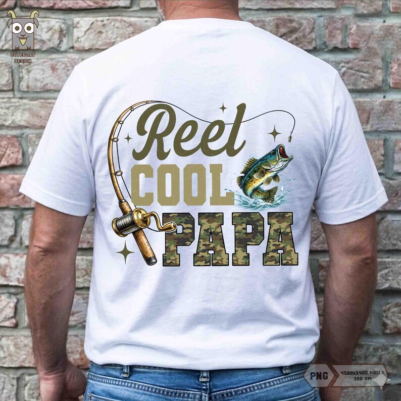 May include: White t-shirt featuring a fishing theme. The design includes a fishing rod, a leaping fish, and the text "Reel Cool Papa" in green and camouflage lettering. A great gift for fishing enthusiasts.