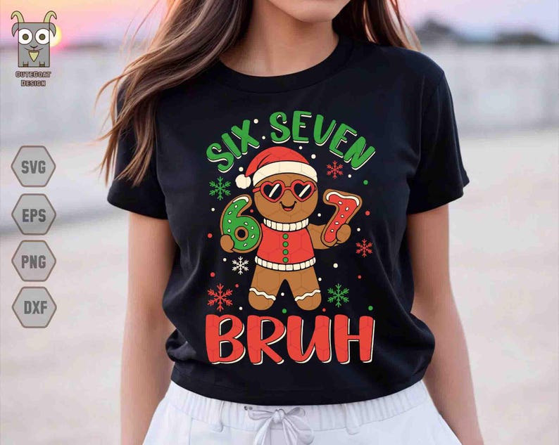 May include: Black t-shirt with a gingerbread man graphic wearing sunglasses and a Santa hat. The text reads "SIX SEVEN BRUH" in green and red. The gingerbread man is holding a number 6 and a number 7.