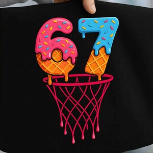 May include: Black graphic design featuring the number 67, designed as a donut and ice cream cone, with a basketball net below. The number 6 is pink with sprinkles, and the 7 is blue with sprinkles. The net is red.