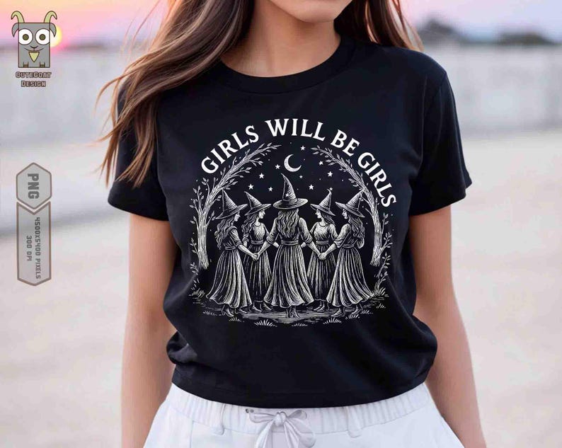 May include: Black t-shirt with the text "GIRLS WILL BE GIRLS" in white. The graphic features five witches holding hands under a crescent moon and stars. The witches are wearing pointed hats and long dresses.
