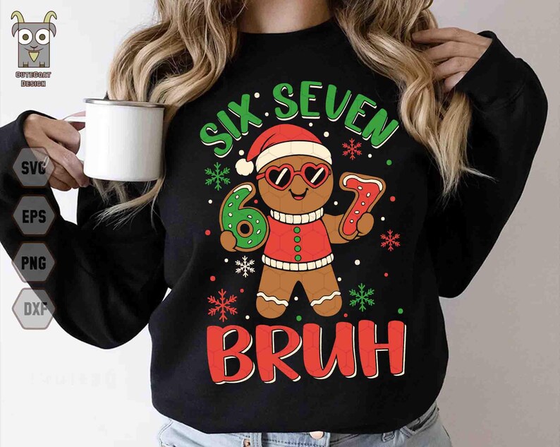 May include: Black sweatshirt with a gingerbread man graphic wearing heart-shaped sunglasses and a Santa hat. The text reads "SIX SEVEN BRUH" in green and red, with snowflakes. The gingerbread man is holding a number 6 and a number 7.