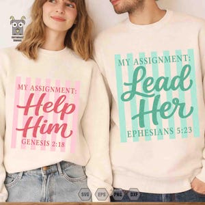 May include: Matching cream-colored sweatshirts with text. One says "MY ASSIGNMENT: Help Him GENESIS 2:18" in pink script over pink stripes. The other says "MY ASSIGNMENT: Lead Her EPHESIANS 5:23" in teal script over teal stripes. The sweatshirts are a couple's matching apparel.