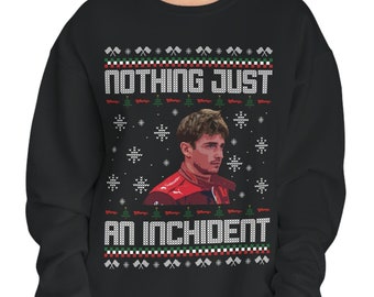 May include: Black Christmas sweater with a red and white snowflake pattern. The sweater features a photo of a race car driver and the text "Nothing Just An Incident."