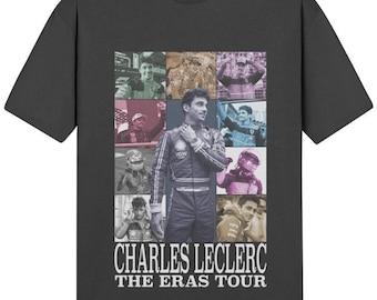 May include: A black t-shirt with a collage of photos of a race car driver. The photos are in different colors and the text "CHARLES LECLERC THE ERAS TOUR" is printed below the collage.