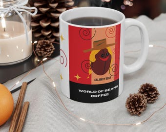May include: White ceramic coffee mug with a red, white, and black design. The design features a cartoon coffee bean wearing a hat and the text "World of Beans Coffee" and "Calamity Bean".