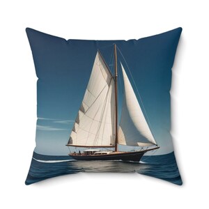 May include: A white sailboat with a brown mast and sails, sailing on a blue ocean under a clear blue sky.
