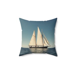 May include: A white sailboat with brown sails and a wooden hull is sailing on a blue ocean under a clear blue sky.