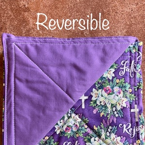 May include: Reversible purple and floral print pot holder with the words "Faith" and "Rejoice" on it.