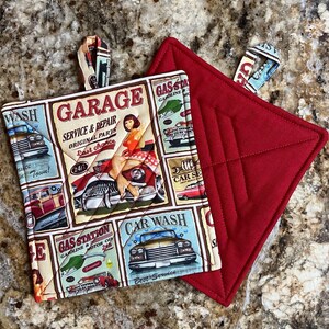 May include: Two red quilted pot holders. One pot holder has a vintage car and gas station themed print with the text "Garage, Service & Repair, Original Parts, Last Chance, Gas Station, Gasoline & Motor Oil, Car Wash, Best Service".