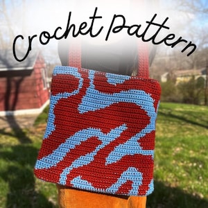 May include: A square crochet tote bag featuring a two-tone wavy pattern in red and light blue. The bag has two matching red crochet shoulder straps. The text "crochet pattern" is printed in black cursive script across the top of the image.