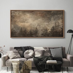 May include: A framed canvas art piece depicting a forest scene. The artwork features silhouetted evergreen trees in shades of brown and black against a muted, textured background. The frame is a light brown color.