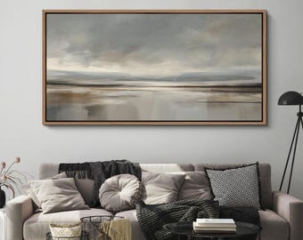 May include: A framed landscape painting with a neutral color palette. The artwork depicts a serene scene with a muted sky, a reflective body of water, and a distant horizon. The frame is a light brown color.