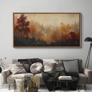 May include: A rectangular landscape painting in a wooden frame depicting a dense forest during autumn. The scene features trees with foliage in shades of deep red, burnt orange, and golden yellow, set against a soft, hazy, and misty background.