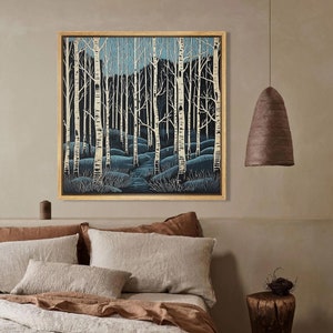 May include: A framed print of a forest scene with white birch trees and a blue sky. The trees are silhouetted against the sky, and the ground is covered in blue and green brush.