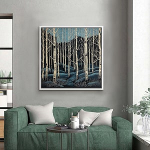 May include: A framed print of a stylized forest scene with white birch trees and a blue path leading into the woods.