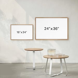 May include: Two wooden framed canvases with white backgrounds and black text. The larger canvas is 24" x 36" and the smaller canvas is 16" x 24". Two white side tables with wooden tops are in the foreground.