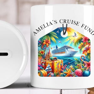 May include: White ceramic money bank featuring a vibrant illustration of a cruise ship, tropical flowers, and luggage. The text "AMELIA'S CRUISE FUND" is printed on the front. The bank has a slot for inserting money.